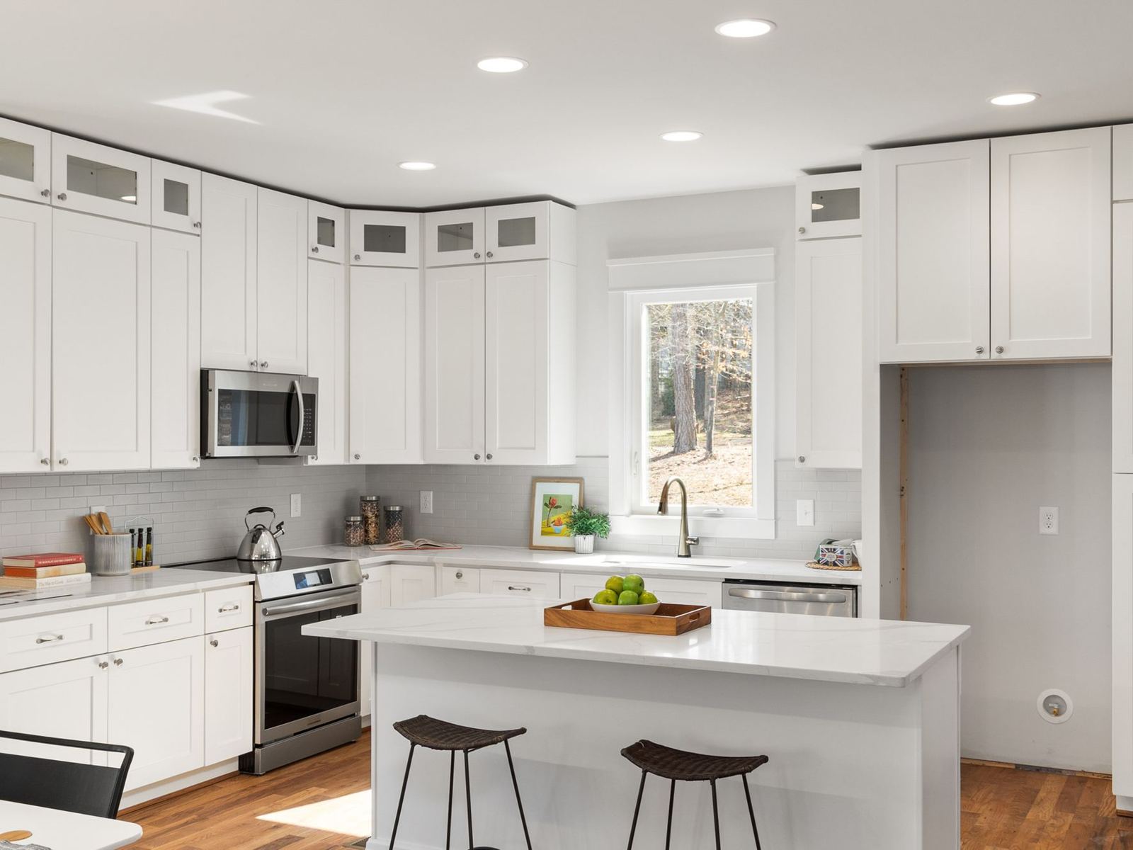 Bright white kitchen with shaker cabinets and a center island